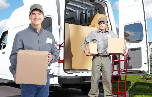 Professional movers loading household items for a local Petts Wood relocation
